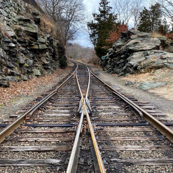Mergins train tracks ahead - Photo by Lance Grandahl on Unspash